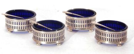 Set of four George V oval open salts with slot pierced decoration, each supported on four cheese