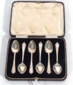 Cased set of six George V coffee spoons with bellflower embossed pointed ends to handles, Birmingham