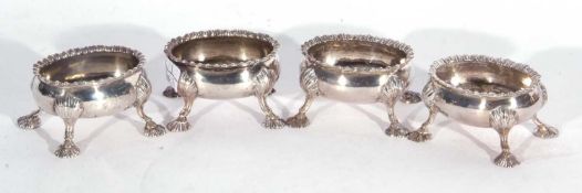 Heavy pair of early George III oval open salts with gadrooned rims and supported on four shell feet,