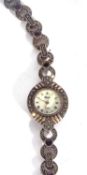 White metal ladies wrist watch featuring a mother of pearl dial with various coloured stones on
