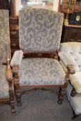 Large 19th century oak framed armchair with floral upholstery and turned legs and an X-formed