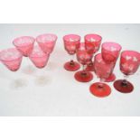 Group of cranberry wine glasses including a set of six of faceted form engraved with leaves and