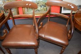 Pair of Victorian mahogany scroll arm carver chairs with brown leather seats