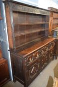 Jacobean Revival oak dresser with two shelf back over a base with three drawers and three doors with