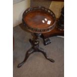 Small reproduction mahogany wine table with circular galleried top over a tripod base, 57cm high