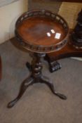 Small reproduction mahogany wine table with circular galleried top over a tripod base, 57cm high