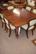 Victorian mahogany extending dining table raised on fluted legs with ceramic casters, together