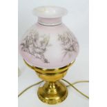 Brass oil lamp, the pink shade decorated with prints of birds
