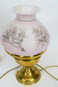 Brass oil lamp, the pink shade decorated with prints of birds
