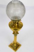 Victorian brass oil lamp with white floral decorated shade on Corinthian column with brass