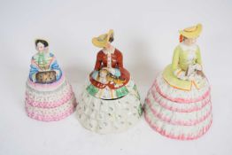 Three Continental pottery biscuit barrels shaped as ladies with crinoline dresses, (3)