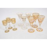 Group of small wine glasses, all with gilt scroll designs, comprising set of six and three further