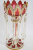 Cranberry coloured Victorian table lustre with Bohemian type white overlay and gilt design with