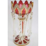 Cranberry coloured Victorian table lustre with Bohemian type white overlay and gilt design with