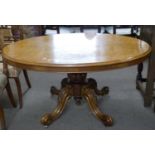 Victorian burr walnut veneered oval loo table raised on a heavy turned column with four outswept