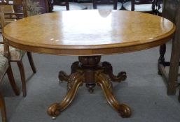 Victorian burr walnut veneered oval loo table raised on a heavy turned column with four outswept