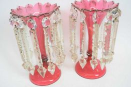 Pair of Victorian cranberry glass table lustres with prismatic droplets, 26cm high (2)
