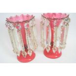 Pair of Victorian cranberry glass table lustres with prismatic droplets, 26cm high (2)