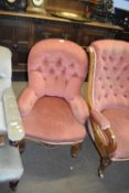 Small Victorian pink upholstered button back armchair raised on short cabriole legs