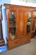 Edwardian mahogany wardrobe with moulded cornice over two mirrored doors and a panelled centre, with