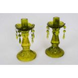 Pair of green glass candlesticks with moulded decoration and droplets from the drip pan, 23cm high