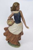 Lladro gres figure of a young girl modelled as a flower seller, 38cm high