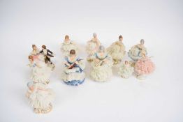 Quantity of Continental porcelain figures of ladies in flounced skirts