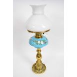 Brass oil lamp with blue ground ceramic reservoir decorated with flowers68cm long