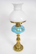 Brass oil lamp with blue ground ceramic reservoir decorated with flowers68cm long