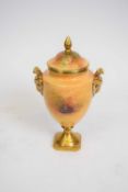Coalport vase decorated with fruit with rams heads handles in gilt signed M Harnett