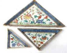 Three Chinese porcelain triangular serving trays with polychrome decoration within blue and white