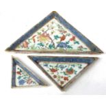 Three Chinese porcelain triangular serving trays with polychrome decoration within blue and white