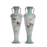 A pair of late 19th century Doulton Burslem vases of slender form with loop handles and mask