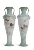 A pair of late 19th century Doulton Burslem vases of slender form with loop handles and mask