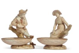 Pair of Worcester Hadley figures of children with small comports or dishes standing by treet