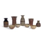 A group of studio pottery wares including vases by Peter Lane (b.1932) together with bowls from