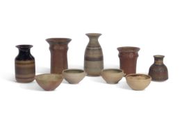 A group of studio pottery wares including vases by Peter Lane (b.1932) together with bowls from