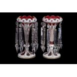 Pair of cranberry table lustres with white overlay in Bohemian style and prismatic droplets, 27cm