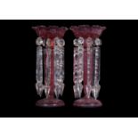 Pair of cranberry glass table lustres with prismatic droplets, 30cm tallslight wear to decoration no