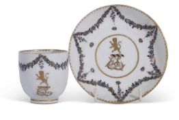 A rare Lowestoft porcelain cup and saucer decorated with an armorial with lion rampant in gilt for