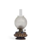 A Doulton Lambeth oil lamp c1882 of compressed form the stoneware body decorated with an incised