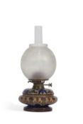 A Doulton Lambeth oil lamp c1882 of compressed form the stoneware body decorated with an incised