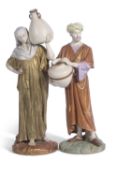 Two large 19th century Hadley Worcester figures of water carriers decorated in shot enamels the base