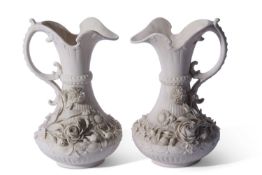 Fine pair of Belleek black mark ewers, the ribbed bodies with applied floral decoration, 22cm