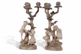 Two large candlestick figures by Worcester both modelled with children by tree stump with three