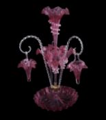 A large Victorian cranberry glass epergne with flower holders and two baskets supported by rope