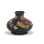 Moorcroft vase with tube lined floral pattern on green ground