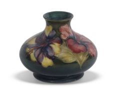 Moorcroft vase with tube lined floral pattern on green ground