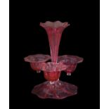 Cranberry glass epergne with petal shaped flower holders above a petal shaped base, 28cm high