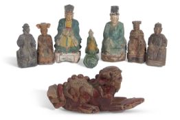 Tang style pottery model of a figure on a chicken, together with a group of seven wooden Han style